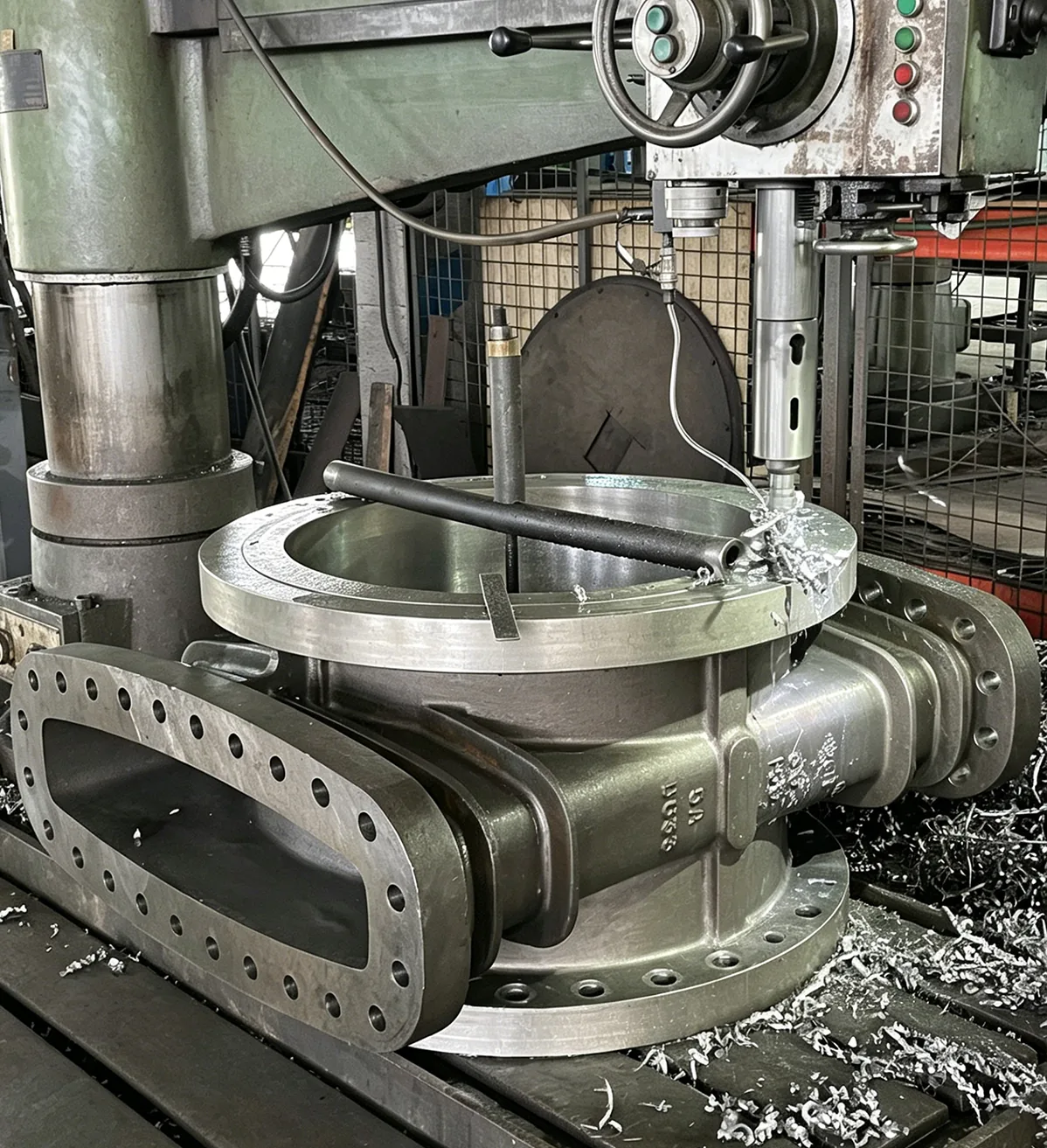 Large industrial valve body undergoing precision machining