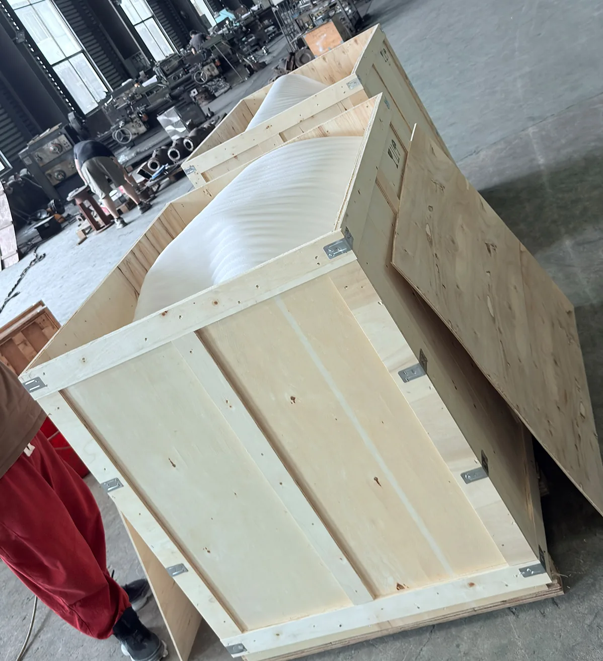 Wooden export packing cases staged inside the Vornet warehouse