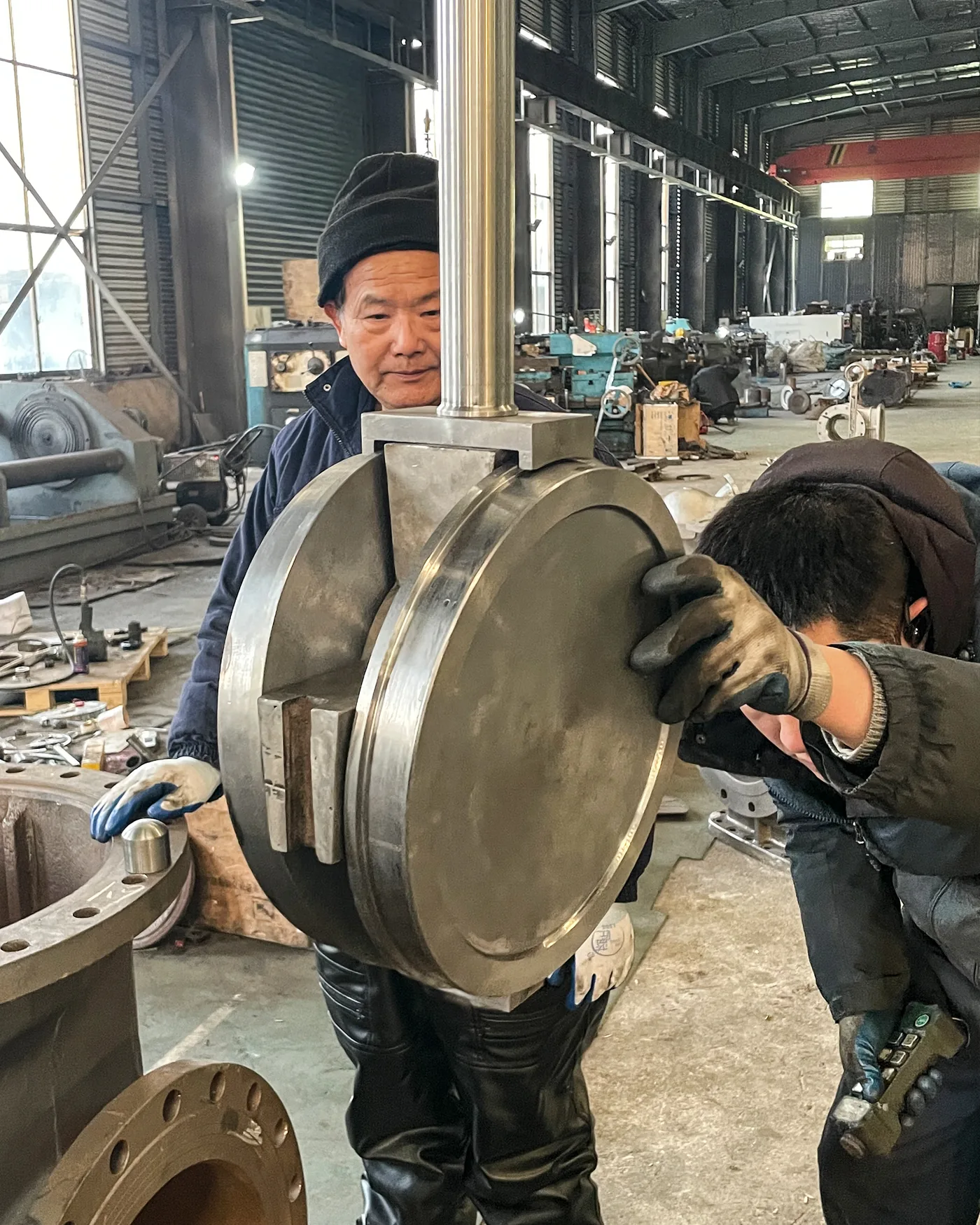 Technicians assembling a large industrial valve in the Vornet workshop