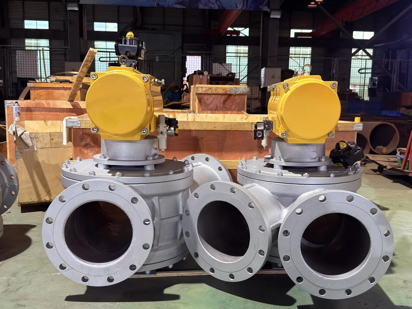 Two completed three-way dust diverter valves with pneumatic actuators in the workshop